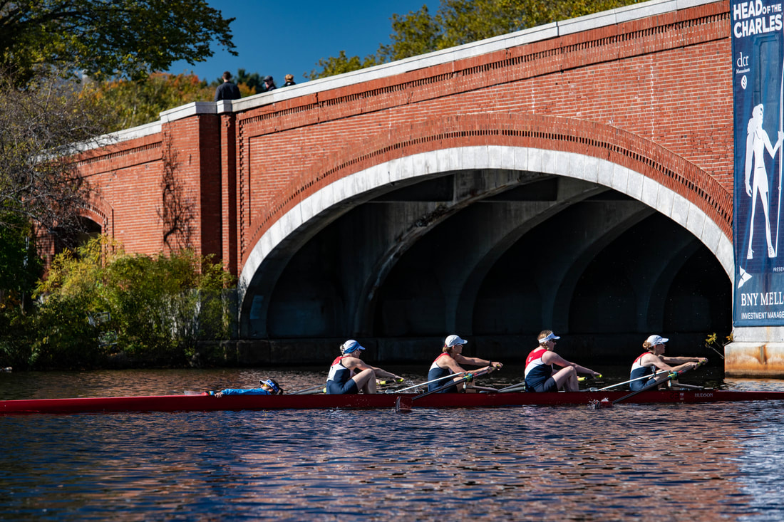 A masters four is shown racing at the Head of the Charles Regatta. 